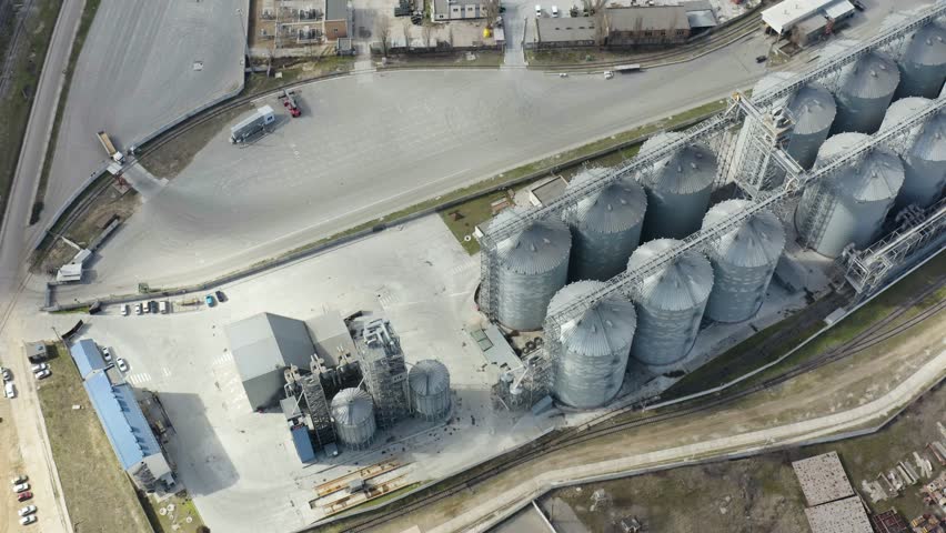 Tanks for processing and storage of soybean and wheat grain. Food crisis 2023. Grain storage elevator, Large metal hangar for grain. Port in Black Sea near Odessa. Ukrainian industry. 