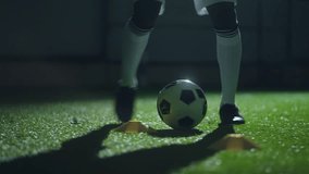 dribbling ball in football hall, closeup of legs of soccer player, running over artificial grass - Powered by Shutterstock - Get 15% off with code: PIKWIZARD15