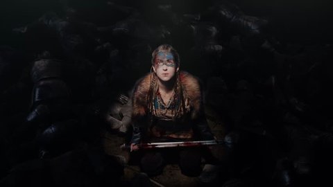 A young brave Viking heroine on the battlefield after the battle, gazing up sitting among the defeated enemies, video and 3D visualization. 3D Illustration - Βίντεο στοκ