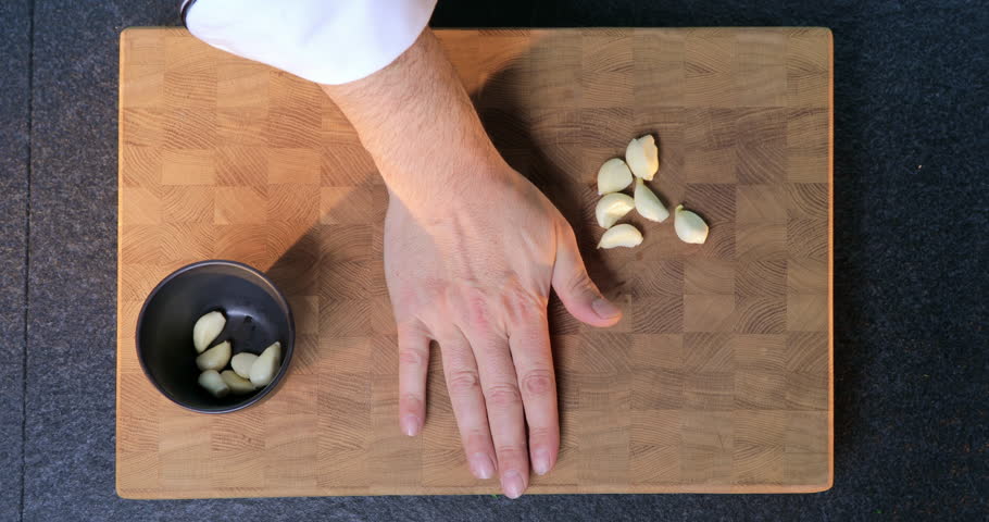 Hands crush. Crush garlic.