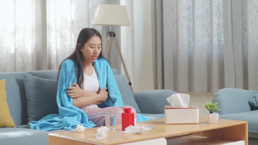 Sick Asian Woman With Blanket Using Thermometer Test For Flu, Cold And Body Temperature On Sofa In The Living Room At Home
 | Shutterstock HD Video #1099402891