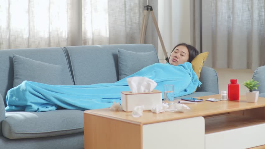 Sick Asian Woman With Blanket Sleeping On Sofa In The Living Room At Home
 | Shutterstock HD Video #1099402897