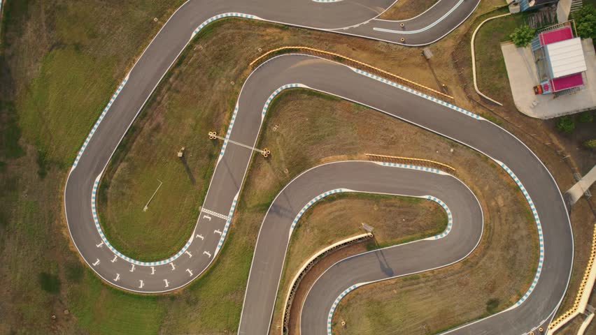 Lowering top down aerial of a go kart track in Spain.