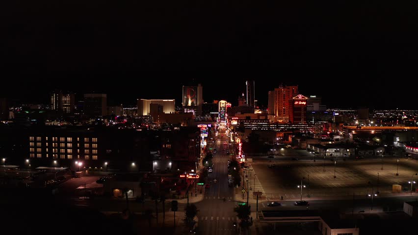Aerial wide rising and panning shot of Fremont Street in downtown Las Vegas at night. 4K