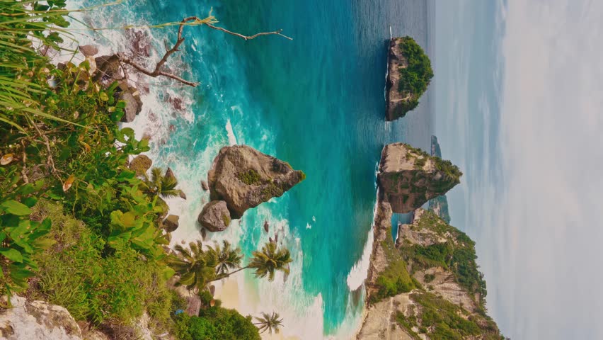 Breathtaking top view on tropical beach Bali with scenery lagoon, sand beach and mountain cliff in ocean on nature background Bali, Indonesia 4K Royalty-Free Stock Footage #1099408421