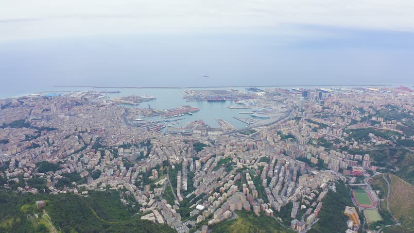 Inscription on video. Genoa, Italy. Central part of the city, aerial view. Ships in the port. Heat burns text, Aerial View