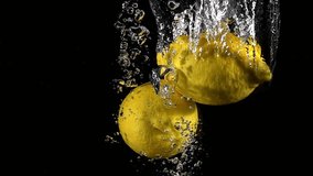 Super slow motion of falling lemon into splashing water. Lemonade cooking concept. Filmed on high speed cinema camera, 4k 1000 fps. - Powered by Shutterstock - Get 15% off with code: PIKWIZARD15