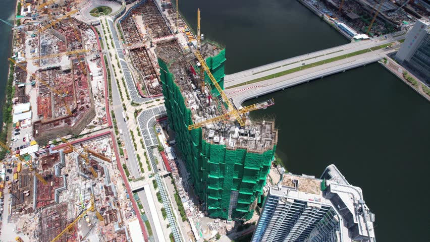 Seside Commercial residential construction site in Kai Tak Cruise Terminal of Hong Kong city, Kwun Tong and Kowloon Bay near Victoria harbor, Aerial drone skyview | Shutterstock HD Video #1099416639