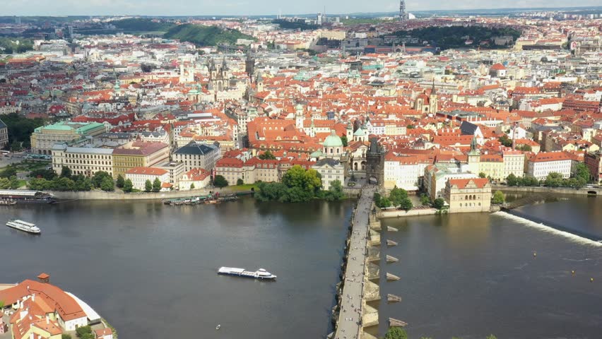 Prague Old Town in Czech Republic with Famous Sightseeing Places in Background. Charles Bridge Iconic 14th century Structure with View, Vltava river and Prague Cityscape. Must Visit City. Drone, 4k