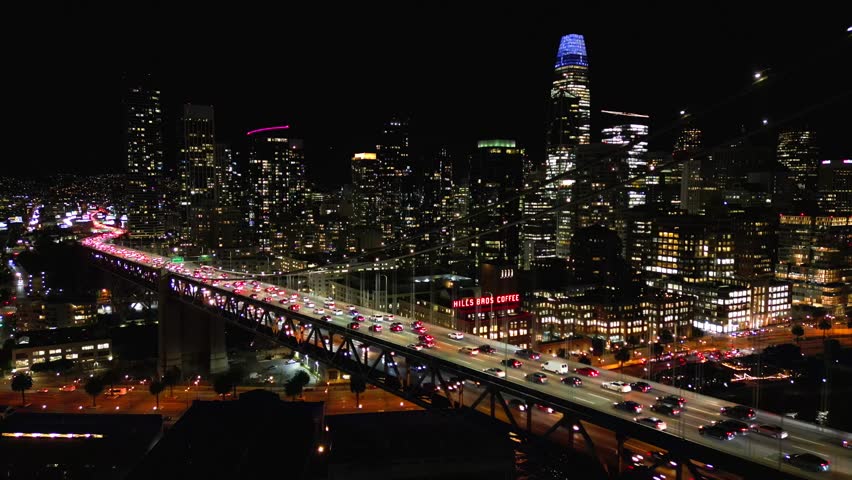 Above San Francisco . Oakland Bay bridge at night. Aerial cinematic shot
