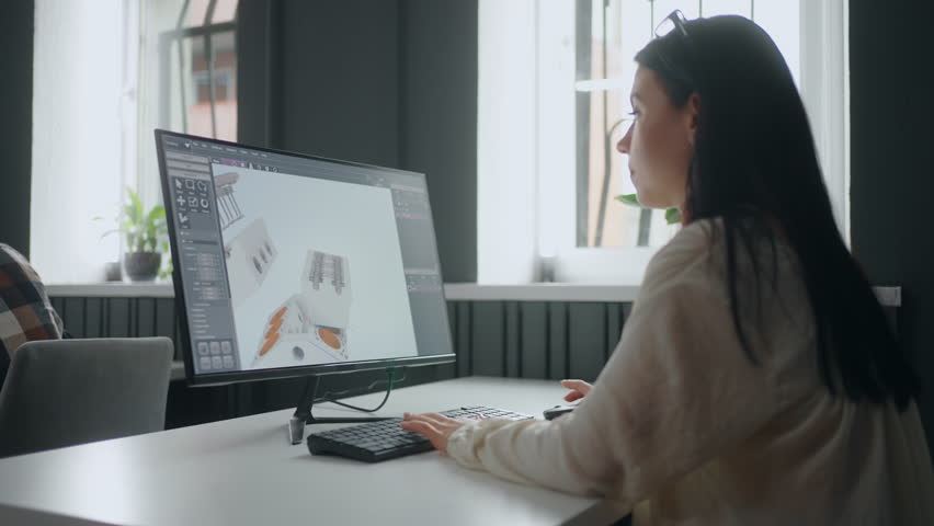 Professional female engineer projecting 3D model of object by CAD program, sitting at table | Shutterstock HD Video #1099420711