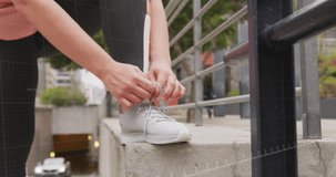 Animation of data processing over caucasian woman exercising and tying shoe laces. Global sports, active lifestyle, computing and data processing concept digitally generated video.