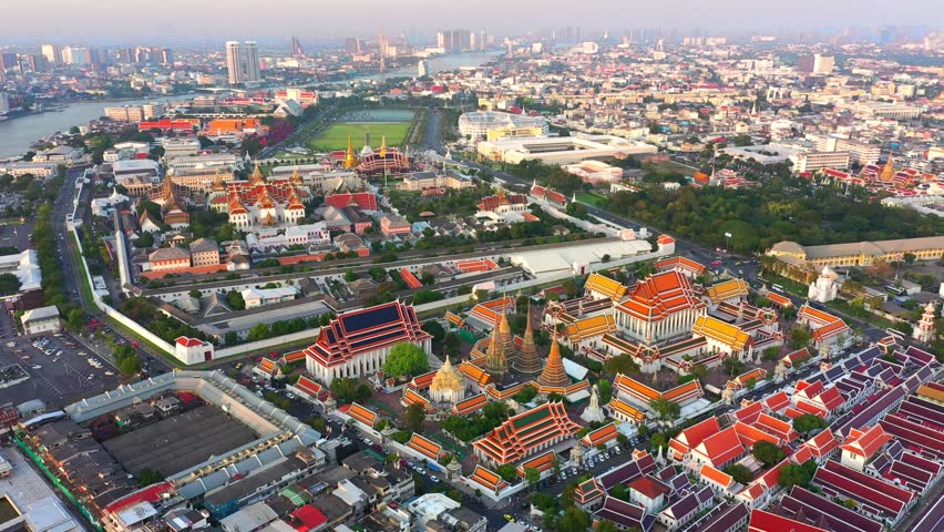 Aerial view Day to Night of Chao Phraya River with Royal Grand Palace and Emerald Buddha Temple Landmark of Bangkok, Thailand. Amazing Drone Footage over the City skyline in twilight.