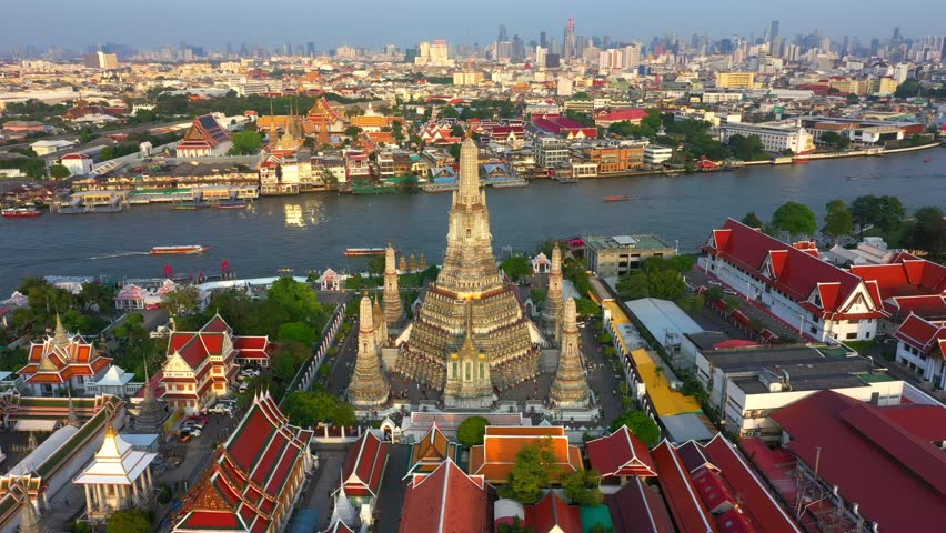 Aerial view Day to Night of Chao Phraya River with Royal Grand Palace and Emerald Buddha Temple Landmark of Bangkok, Thailand. Amazing Drone Footage over the City skyline in twilight.