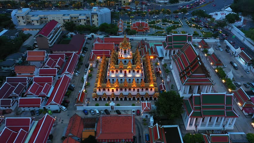 Aerial view Day to Night of Chao Phraya River with Royal Grand Palace and Emerald Buddha Temple Landmark of Bangkok, Thailand. Amazing Drone Footage over the City skyline in twilight.