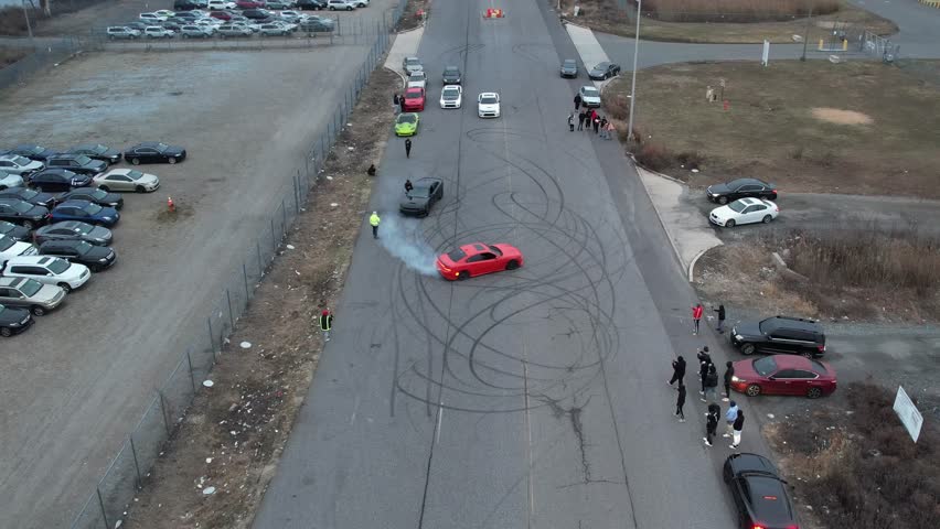 Aerial Drone View of Cars Burning Rubber and Street Racing