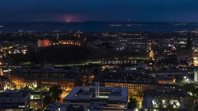 Establishing Aerial View Shot of Edinburgh UK, Scotland United Kingdom at night evening, slow track left, super clear image