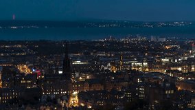 Establishing Aerial View Shot of Edinburgh UK, Scotland United Kingdom at night evening, city center, waterfront
