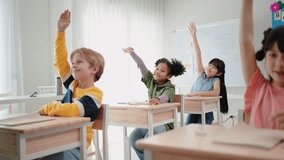 Elementary school students are sitting in the classroom at school and are raising their hands when the teacher asks - Powered by Shutterstock - Get 15% off with code: PIKWIZARD15