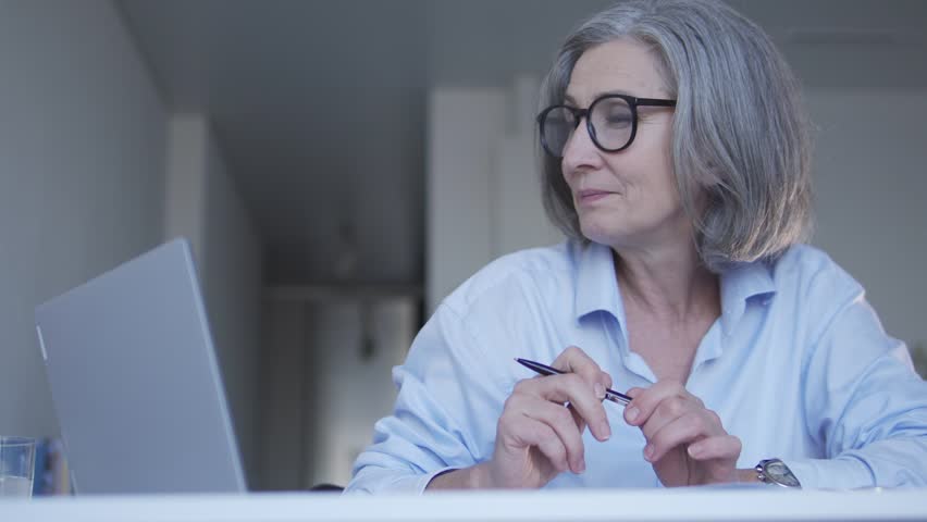 Mature woman internet shop manager receiving order from client, making notes | Shutterstock HD Video #1099434899
