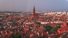 Establishing Aerial View Shot of Strasbourg Fr, capital of European Union, Bas-Rhin, France, sunseting sun gives red wonderful light, rainbow over cathedral