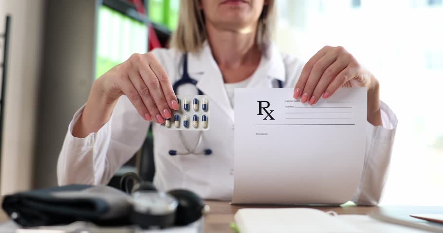 Doctor holding form with prescription and blister of medicines in clinic closeup 4k movie slow motion | Shutterstock HD Video #1099436433