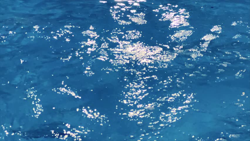 Ripple water in swimming pool with sun reflection. Background shot of pool water surface pattern. Ripple wave and clear turquoise water surface texture	 | Shutterstock HD Video #1099437645