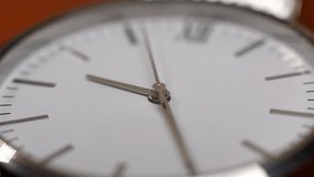 An extremely close-up of the rotation of the second hand of a clock. Video filming of a watch in macro video shooting.