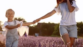 Mothers day. young mom with little child daughter holding hands and walking in a blooming lavender field. Family of two having fun and playing in meadow field on summer holiday. - Powered by Shutterstock - Get 15% off with code: PIKWIZARD15
