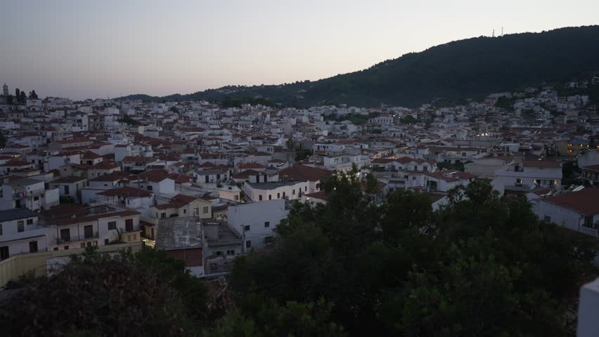 The Old Port and town from elevated position at dusk, Skiathos Town, Skiathos, Sporades Islands, Greek Islands, Greece, Europe | Shutterstock HD Video #1099443651
