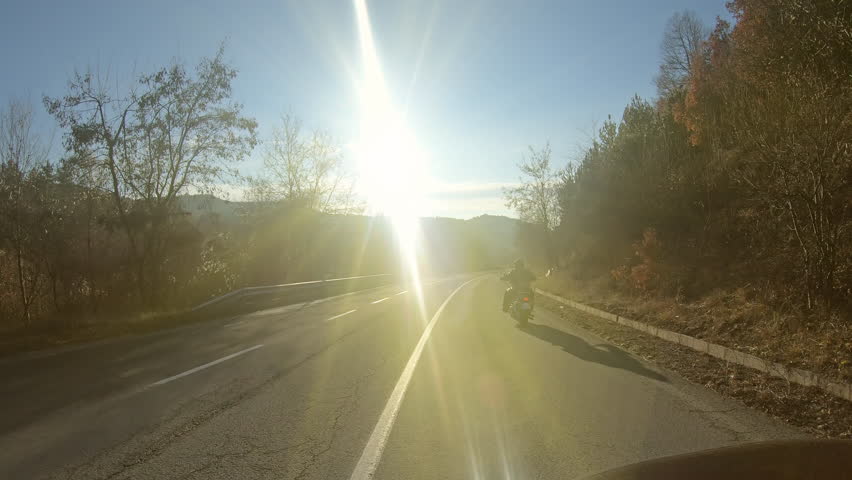 Motorbike riding on the road with sunset light | Shutterstock HD Video #1099444463