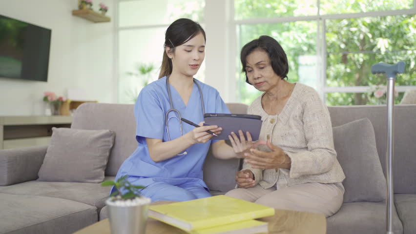 Woman nurse takes care of sick old senior elderly patient sitting on wheelchair in hospital in medical and healthcare treatment. Asian Thai people lifestyle. Family encourage. | Shutterstock HD Video #1099448497
