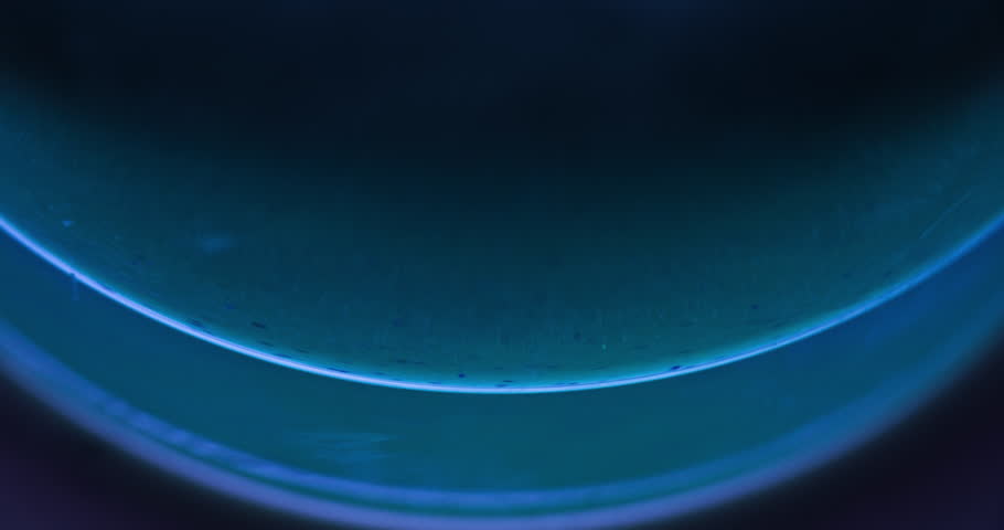 Defocused glow. Fluid art. Underwater reflection. Blur blue light flare particles in bubble on dark abstract background for intro. Shot on RED Cinema camera. | Shutterstock HD Video #1099451977