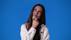 4k slow motion video of one girl thinking about something on blue background.
