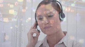 Animation of connections with icons over businesswoman using phone headset. Global business, computing, connections and data processing concept digitally generated video.