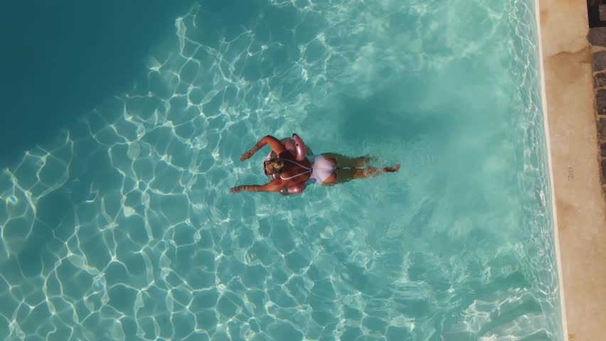Top view of woman is swimming in pool hotel, summer time, Oludeniz, drone footage | Shutterstock HD Video #1099456163