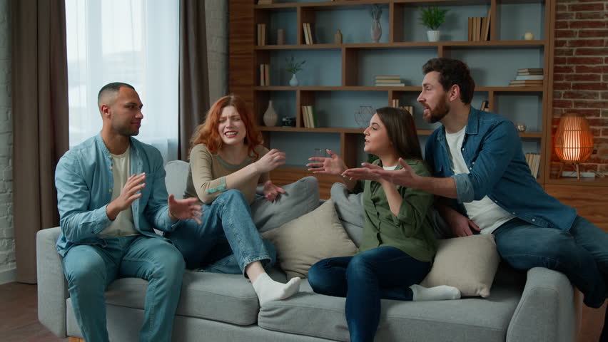 Group of diverse ethnic multiracial friends girls guys sit on sofa at home talking argue conflict friendly dispute debate discussing problem ambitious expressive men women arguing discussion indoors | Shutterstock HD Video #1099456517