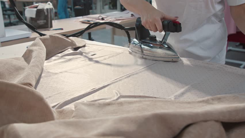 Ironing professional. Presser in sewing clothes pressed., an Industrial Video by Mark Okhotin
