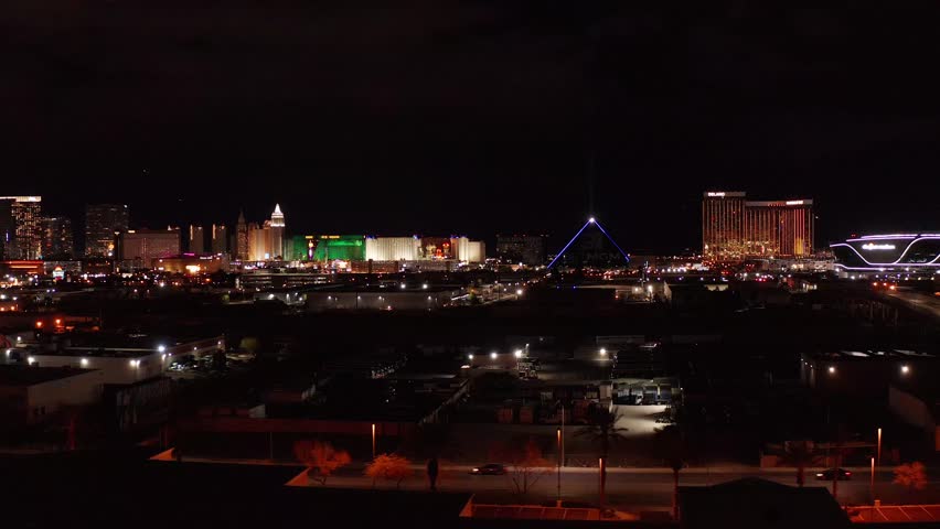 Aerial close-up panning shot of the south Las Vegas Strip at night. 4K Royalty-Free Stock Footage #1099457917
