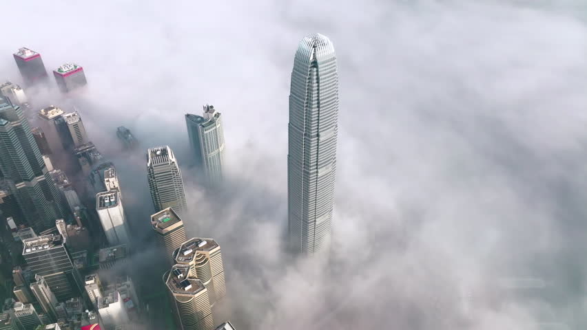 Coastal morning fog surrounding the International Finance Center in Hong Kong. Slow left rotational wide angle birds eye view aerial shot at, morning after sunrise | Shutterstock HD Video #1099457977