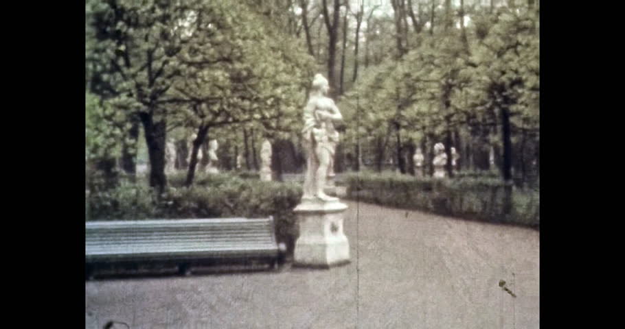 Green garden with marble women sculptures in summer city. 1980s Petersburg, Russia. Beautiful park with ancient monuments, landmark. Old archives. Vintage, archival color film. Retro, historic archive | Shutterstock HD Video #1099460903