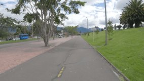 Video recorded in 5K on a bicycle path in the city of Bogota surrounded by a library and the main avenue that runs through the city from east to west