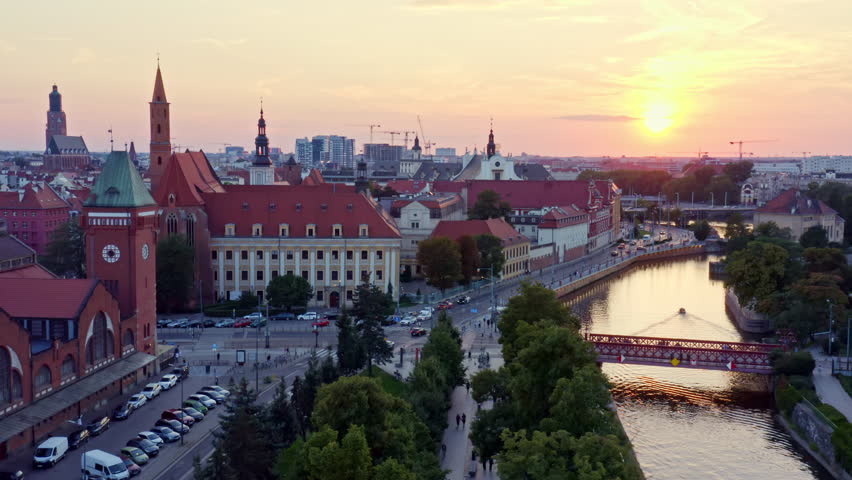 4k aerial footage view of the Oder River, old center of the city of Wroclaw in Poland. Summer scene in the town on weekend peacefull evening. classical architecture. Buildings with red roofs. Europe.