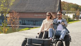 Front view of happy and carefree couple enjoying speed and active rest. Beloved woman and man driving buggy, smiling, enjoying freedom, woman hugging man. Concept of active recreation. - Powered by Shutterstock - Get 15% off with code: PIKWIZARD15
