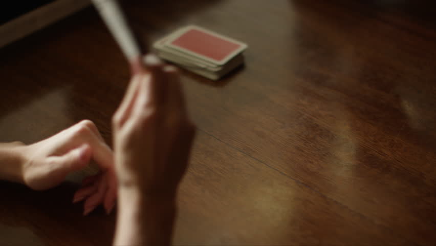 Playing cards at the table, hands with playing cards, close-up