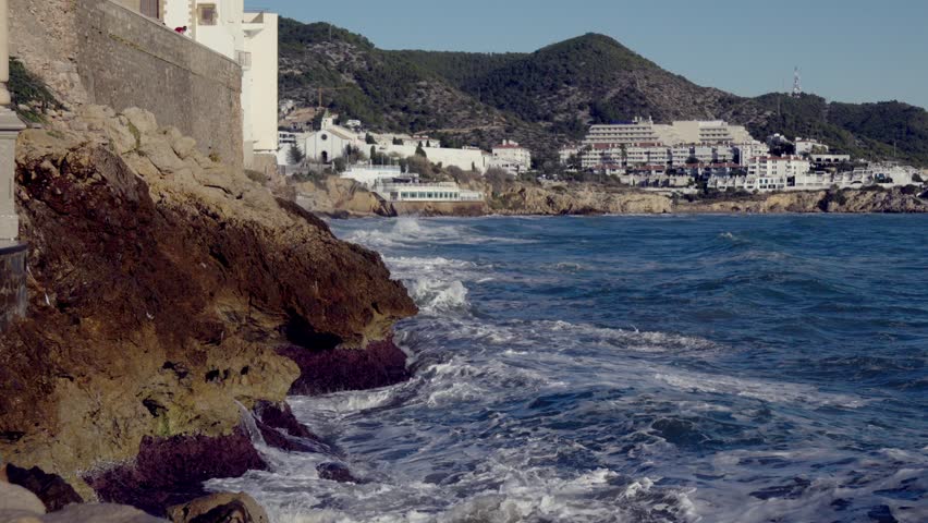 Big waves crash against the rocky shore