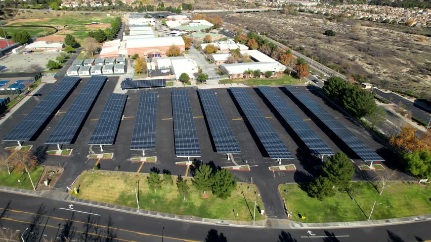 Aerial Solar Panels at school parking lot, Clean Energy Golden Sunlight