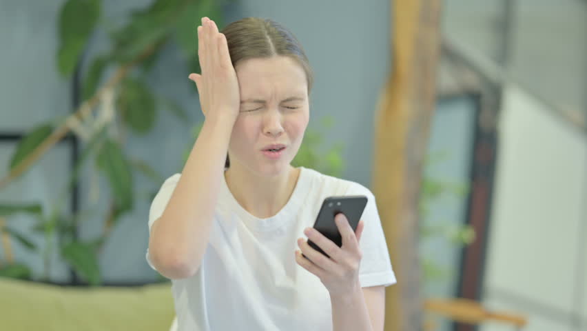 Portrait of Young Woman Upset by Loss on Smartphone | Shutterstock HD Video #1099481477
