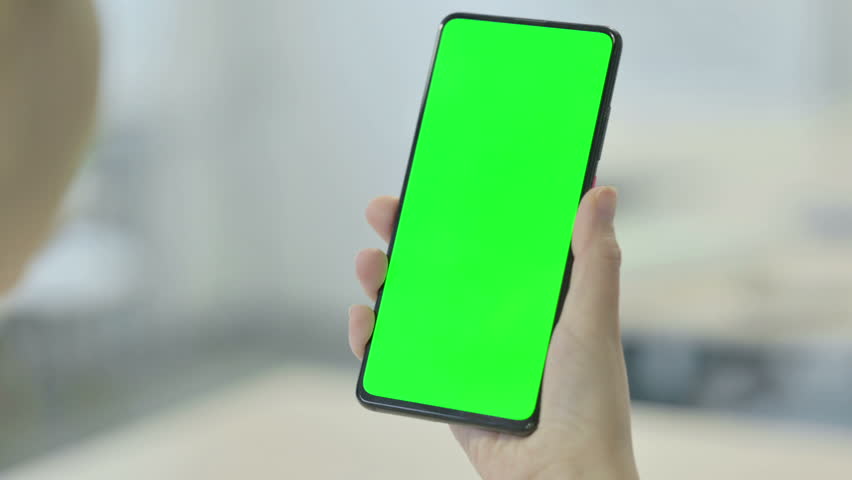 Woman Looking at Smartphone with Green Chroma Screen | Shutterstock HD Video #1099481537