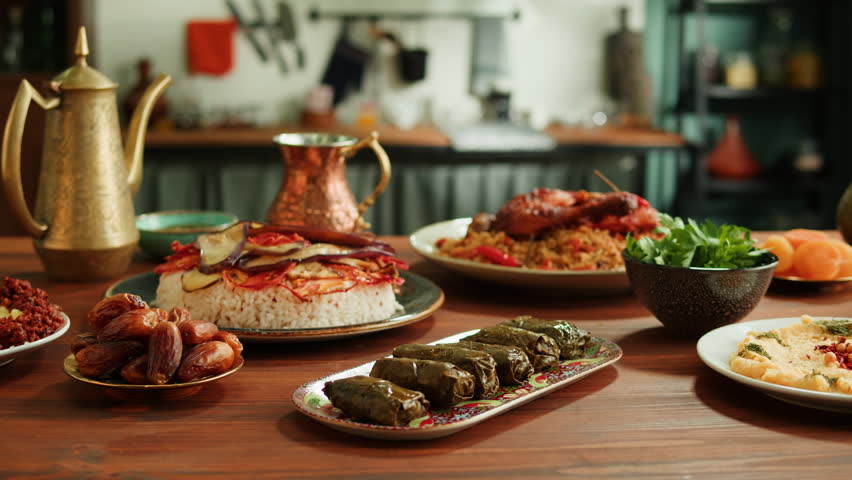 Kabsa, hummus, maqluba, maqluba, tabbouleh close-up, rice and meat dish, middle eastern national traditional food. Muslim family dinner, Ramadan, iftar. Arabian cuisine. Royalty-Free Stock Footage #1099482977